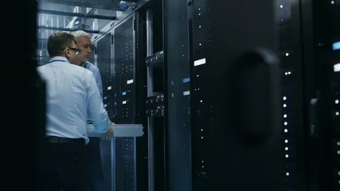 Two Server Technicians Install Hardware in Server Rack.  Stock Footage 74630781