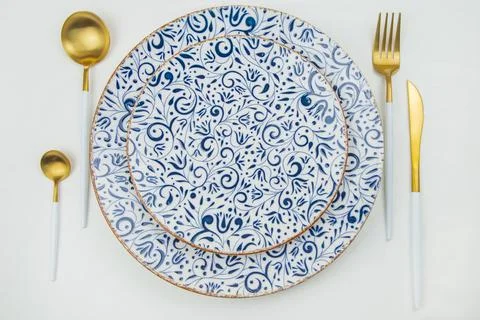 Two serving plates with blue patterns and a gold border, gold - white appliances 스톡 사진