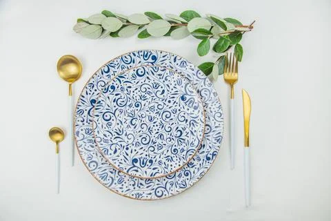 Two serving plates with blue patterns and a gold border, gold - white appliances 스톡 사진