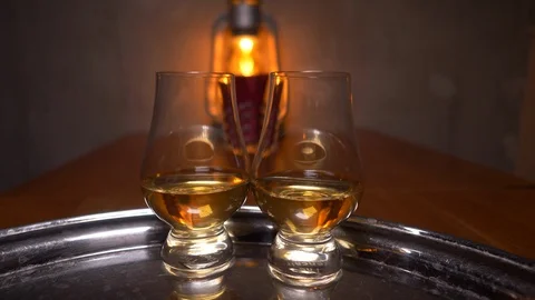 Two servings of whiskey on a tray are served. Bar, table with a kerosene lamp. Stock Footage 124283467