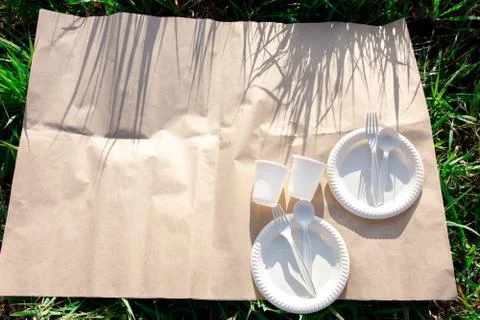 Two sets of disposable biodegradable tableware for an outdoor picnic. Stock Photos