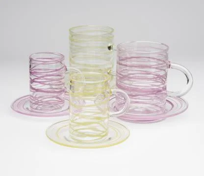 Two Sets of Drinking Mugs with Yellow and Purple Streaks Stock Photos