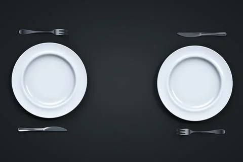 Two sets of empty white plate with knife and fork on a dark table. View from Stock Photos