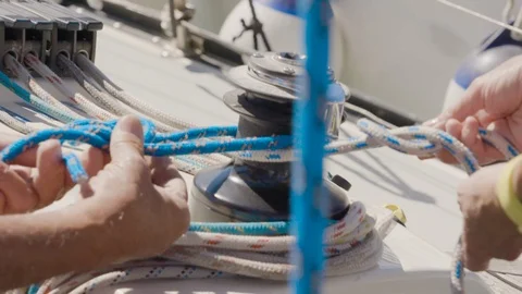 Two sets of hands on a sailboat work with ropes Video stock 94041987