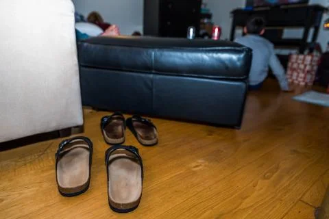 Two sets of slippers on the floor next sofa christmas party 스톡 사진