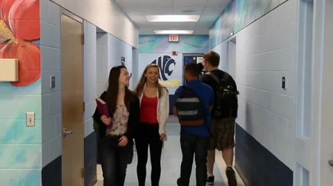 Two sets of students males and females pass in hallway Video stock 37211477