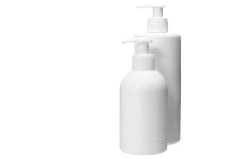 Two several size matte opaque white plastic bottle with dispenser. Stock Photos