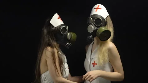 Two sexual nurses in gas mask Stock Footage 90352264