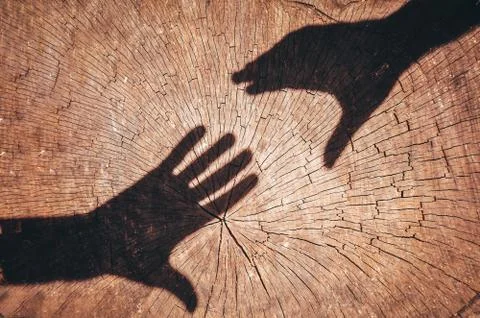 Two shadow shaking hands as a sign of love and friendship Stock Photos