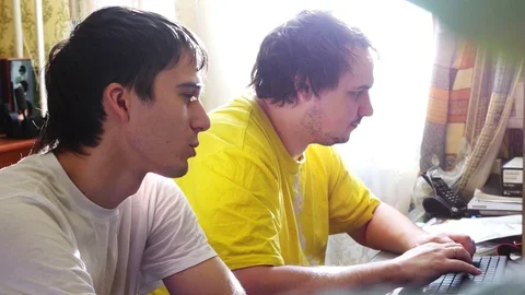 Two shaggy IT programmers are working on computer at home. 3840x2160, 4k Stock Footage 74342514