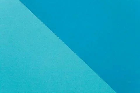 Two sheets of colored paper on the diagonal, light blue and dark blue. Stock Photos
