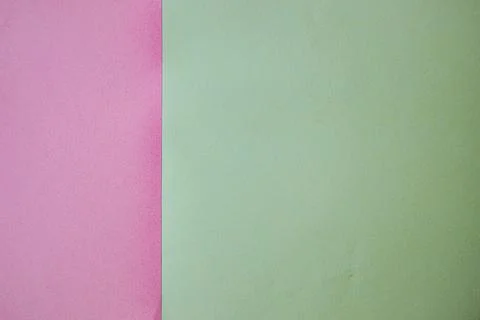 Two sheets of colored paper, one pink and one green, arranged side by side .. Stock Photos