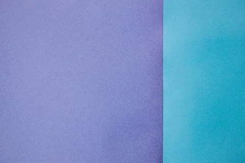 Two sheets of colored paper, one purple and one turquoise, arranged side by.. Stock Photos