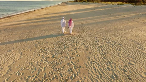 Two Sheiks Walking On The Shoreline Stock Footage 276852518
