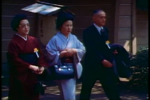 Two Shinto priests pass in a ceremony at Kamakura in Japan, Stock Footage