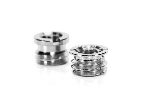 Two shiny threaded metal inserts on white background Stock Photos