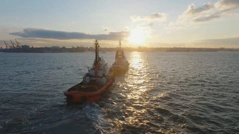 Two ships slowly sailing into the sunset. A beautiful sea perspective. A Video stock 128974135