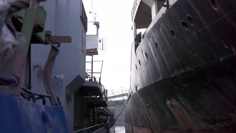 Two ships stand next to a small gap in the port. Footage. Gray ladder... Vidéo 137855317
