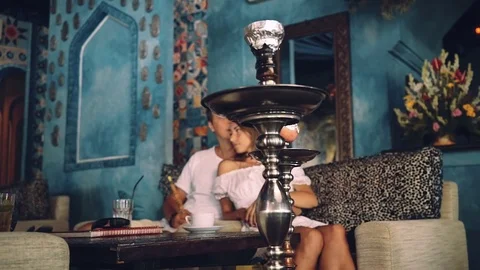 Two shisha closeup, blurred romantic couple in background Stock Footage 71386356