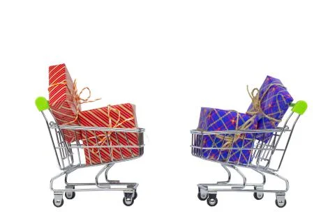 Two shopping carts with gift boxes on a white background. Stock Photos