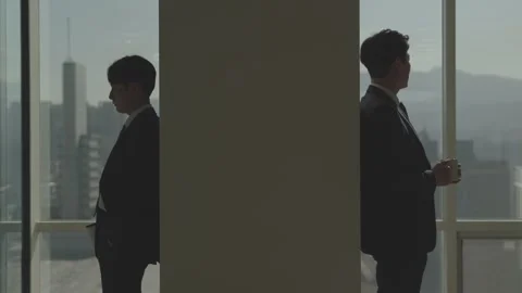 Two Silhouetted Businessmen Facing Each Other in Dark Office Stock-Footage 337933185