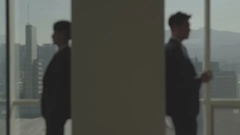 Two Silhouetted Businessmen in Soft Light Office Setting 스톡 동영상 337933460