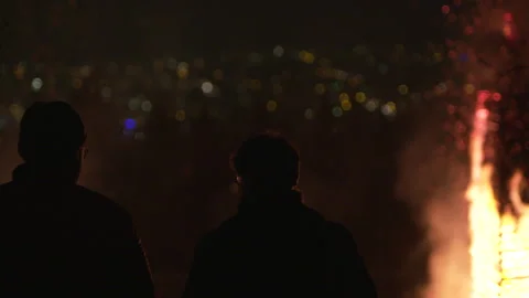 Two Silhouettes Of People Standing On Top Of Hill, Overlooking City Night Stock Footage 267010176