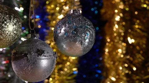 Two silver balls and golden ball hanging on a Christmas tree Stock Footage 121482230