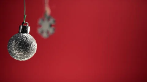 Two silver Christmas ball and snowflake decoration with red background Stock Footage 255784859