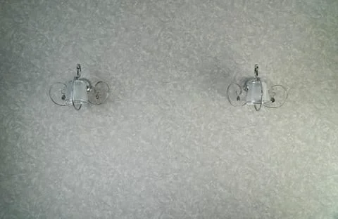 Two silver lamp have light gray wall is background for interior design. The l 스톡 사진