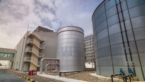 Two silver Water Tanks with fence timelapse hyperlapse Stock Footage