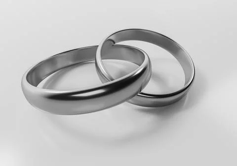 Two silver wedding rings interlinked as a concept of love marriage and eter.. Stock Photos