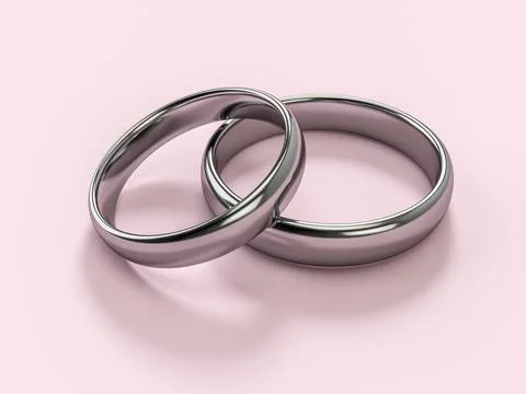 Two silver wedding rings soft pink background Illustrazione stock