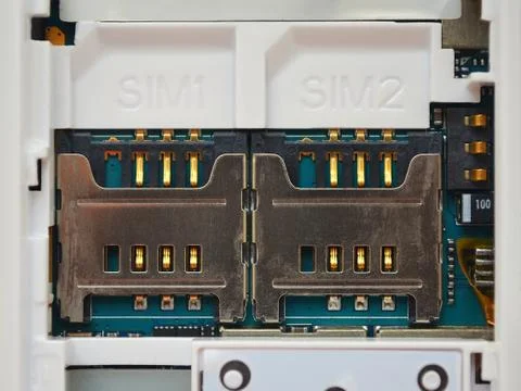 Two SIM card slots in an old white mobile phone Foto stock