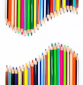 Two similar row of different colored pencil crayons arranged facing each-othe Stock Photos