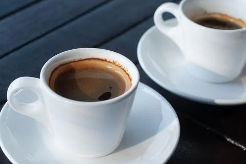 Two single and double cups of espresso coffee Stock Photos