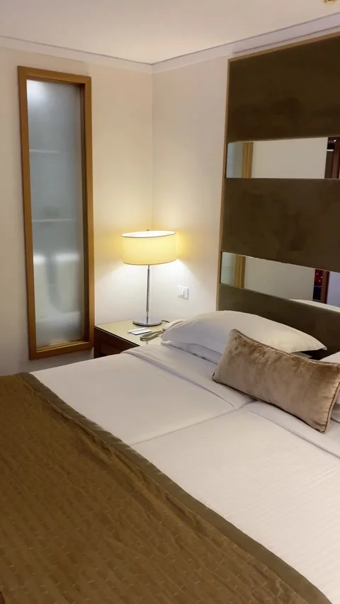 Two single beds stand side by side in a hotel. Vertical video Stock Footage 286115032