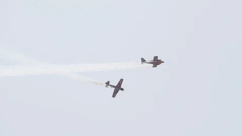 Two single-engine aircraft perform tricks in the sky Stock Footage 115544390