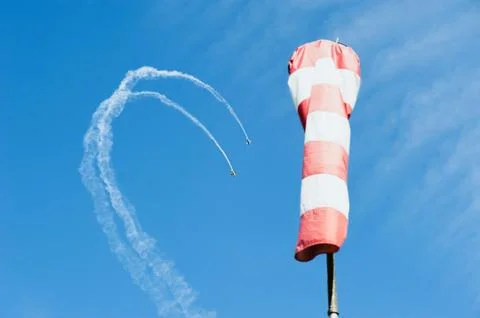 Two single-engine airplane in the sky draw a loop out of clouds on background Foto stock