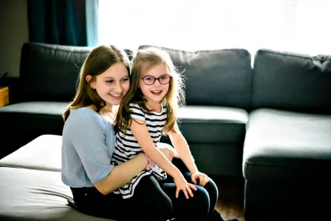 Two sister having fun on the sofa Stock-Fotos