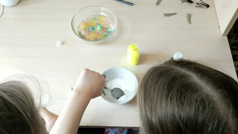 Two sisters are engaged in manual work, creating some figures for toys. Kindness Video stock 151604977