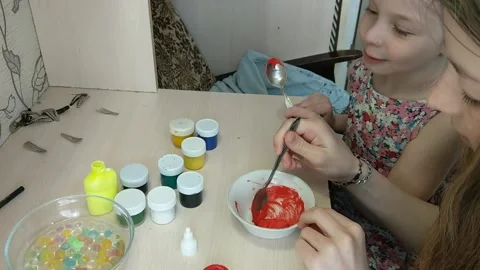 Two sisters are engaged in manual work, creating some figures for toys. Kindness Vídeo Stock 151604987