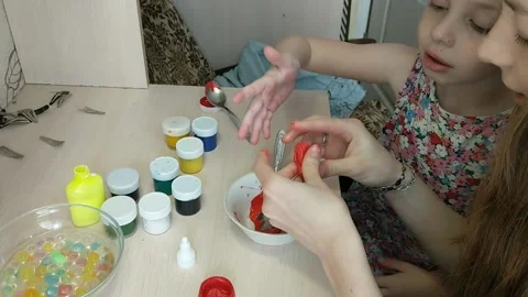 Two sisters are engaged in manual work, creating some figures for toys. Kindness Video stock 151604997