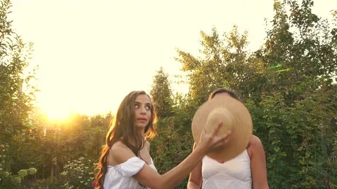Two sisters are fooled with a hat 스톡 동영상 76258133