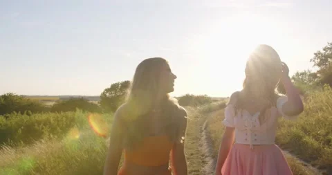 Two sisters are walking in the field in summer. Stock Footage 204145059