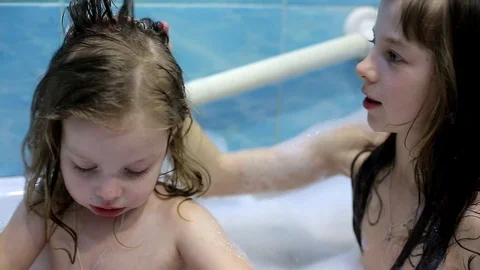 Two sisters bathe in the bathroom Stock Footage 103409584