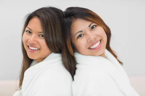 Two sisters in bathrobes posing for the camera 写真素材