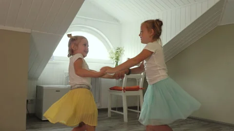 Two sisters in colored skirts are having fun at home. Stock Footage 143318727