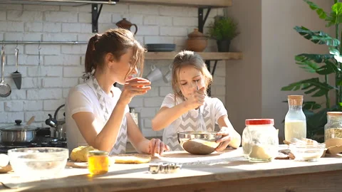Two sisters cooking together.  Stock Footage 106238848