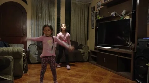 Two sisters dancing in the living room Stock Footage 167373311